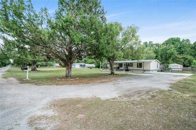 8356 W Tawny Rose, Crystal River, FL 34429 - view of front of house featuring covered porch, a front lawn, and gravel driveway