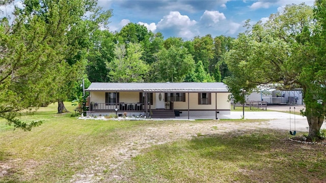 8356 W Tawny Rose, Crystal River, FL 34429 - view of front of home with covered porch, a front lawn, and dirt driveway