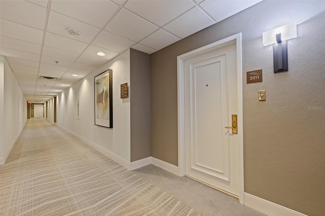 1 Beach Dr SE Unit 2011, Saint Petersburg, FL 33701 - hallway featuring a textured wall, a paneled ceiling, light colored carpet, baseboards, and recessed lighting