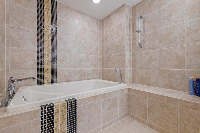 1 Beach Dr SE Unit 2011, Saint Petersburg, FL 33701 - bathroom with a bath, tile walls, and a tile shower
