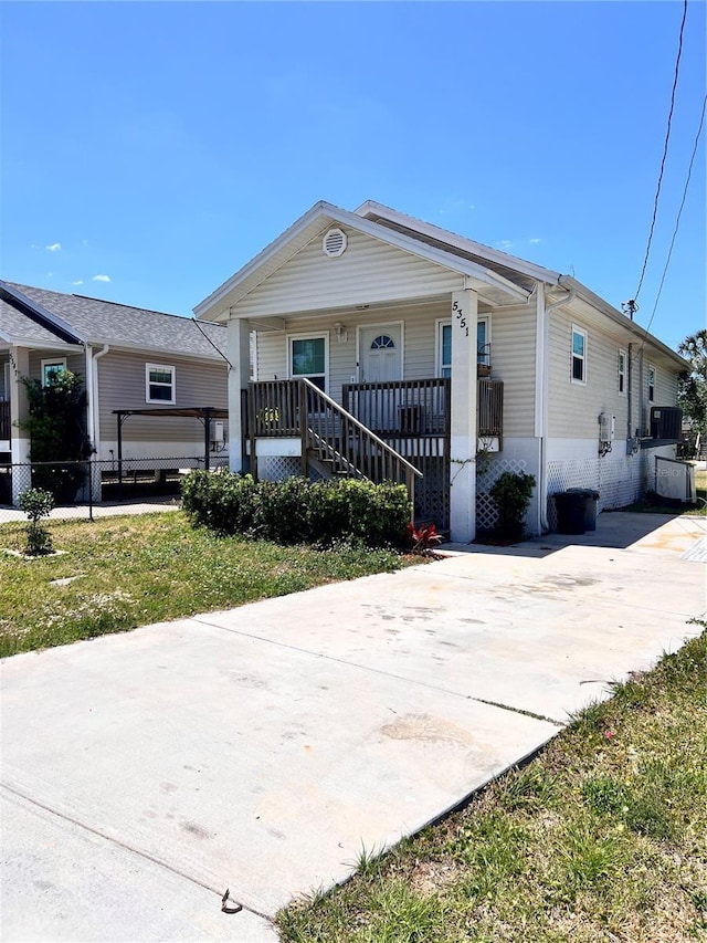 5351 Leisure Ln, New Port Richey, FL 34652 - view of front of house with covered porch, concrete driveway, and stairs