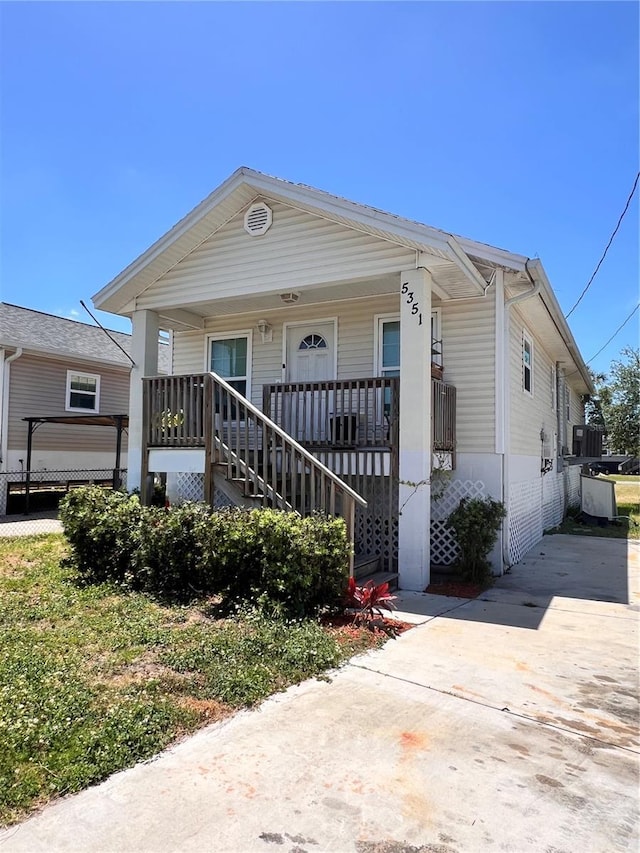 5351 Leisure Ln, New Port Richey, FL 34652 - view of front of house with a porch, stairway, and driveway