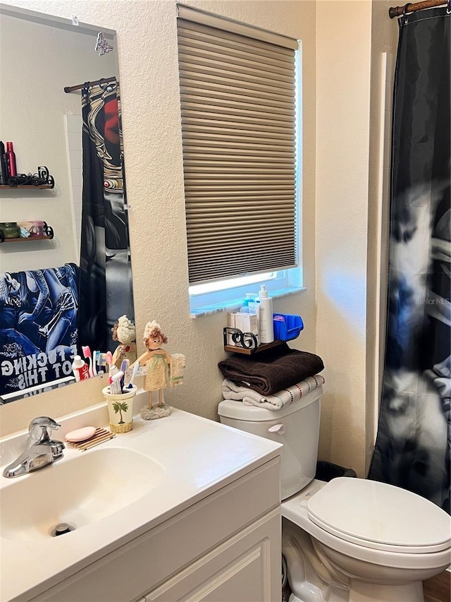 5351 Leisure Ln, New Port Richey, FL 34652 - full bathroom featuring toilet, vanity, a textured wall, and a shower with curtain