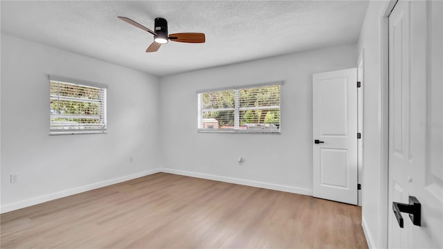603 Amana Ave, Brandon, FL 33510 - unfurnished bedroom with multiple windows, light wood finished floors, baseboards, a textured ceiling, and a closet
