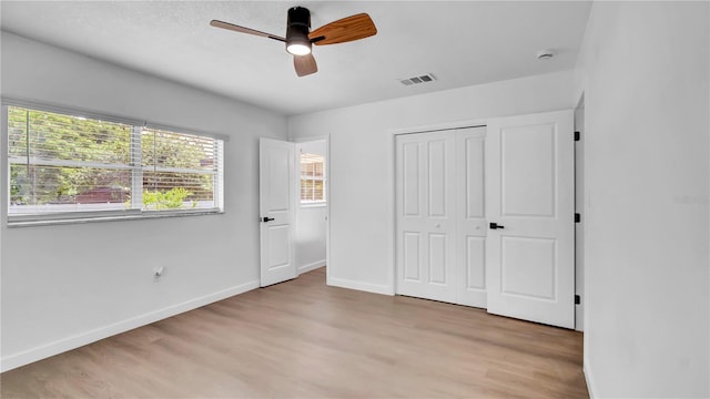 603 Amana Ave, Brandon, FL 33510 - unfurnished bedroom featuring light wood-style floors, baseboards, a closet, and a ceiling fan