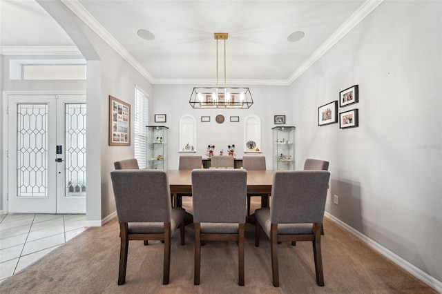 2814 Duncan Tree Cir, Valrico, FL 33594 - dining room with a chandelier, ornamental molding, arched walkways, light colored carpet, and baseboards