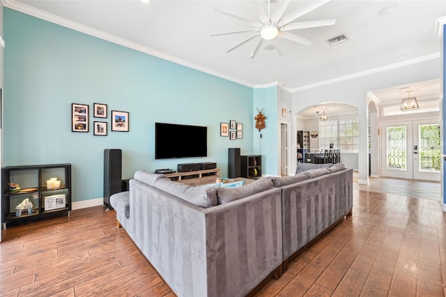 2814 Duncan Tree Cir, Valrico, FL 33594 - living room with arched walkways, a ceiling fan, wood-type flooring, baseboards, and ornamental molding