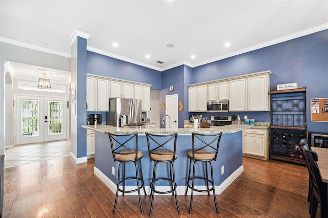 2814 Duncan Tree Cir, Valrico, FL 33594 - kitchen featuring appliances with stainless steel finishes, an island with sink, dark wood-type flooring, a kitchen breakfast bar, and a sink