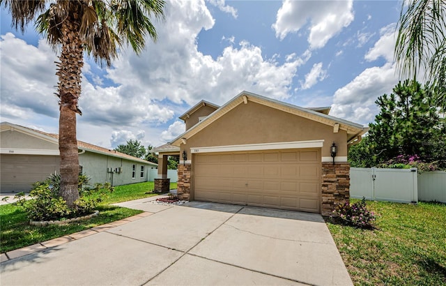 3305 Hoylake Ct, Land O Lakes, FL 34638 - view of front of home featuring stone siding, stucco siding, concrete driveway, and a garage