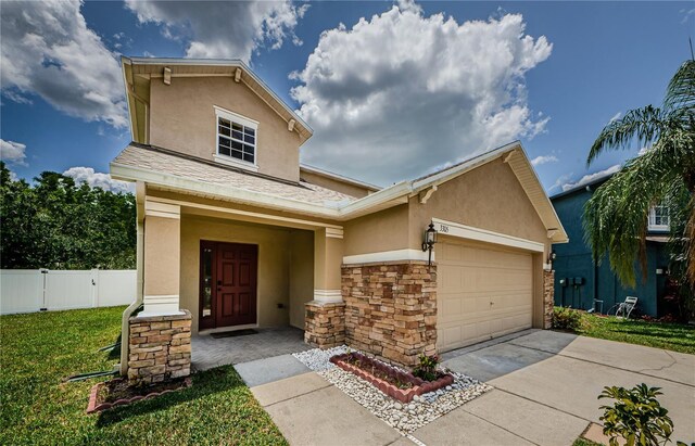 3305 Hoylake Ct, Land O Lakes, FL 34638 - view of front of house with stucco siding, concrete driveway, stone siding, and an attached garage