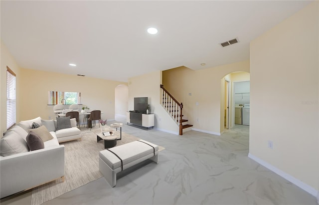 3305 Hoylake Ct, Land O Lakes, FL 34638 - living area with arched walkways, washing machine and clothes dryer, stairway, light marble finish flooring, and recessed lighting