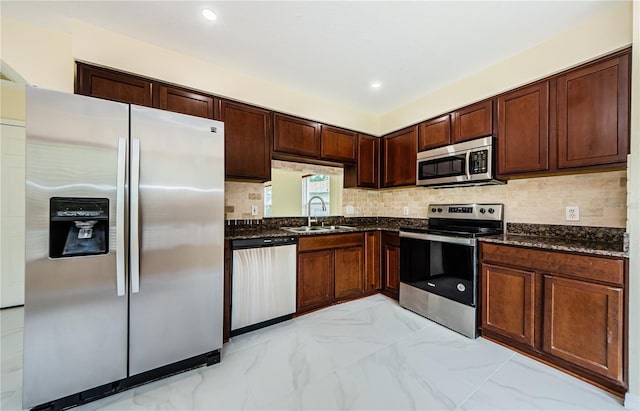 3305 Hoylake Ct, Land O Lakes, FL 34638 - kitchen featuring appliances with stainless steel finishes, light marble finish floors, dark stone counters, tasteful backsplash, and recessed lighting