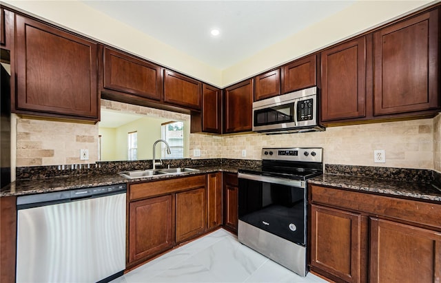 3305 Hoylake Ct, Land O Lakes, FL 34638 - kitchen with stainless steel appliances, backsplash, dark stone countertops, and light marble finish flooring