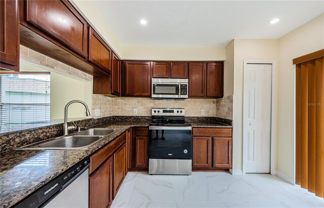 3305 Hoylake Ct, Land O Lakes, FL 34638 - kitchen with appliances with stainless steel finishes, light marble finish floors, decorative backsplash, dark stone counters, and recessed lighting