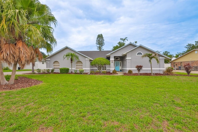 1034 Brighton Way, Lakeland, FL 33813 - ranch-style house featuring stucco siding and a front yard