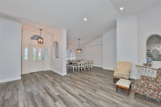 1034 Brighton Way, Lakeland, FL 33813 - entrance foyer with wood finished floors, a chandelier, baseboards, recessed lighting, and arched walkways