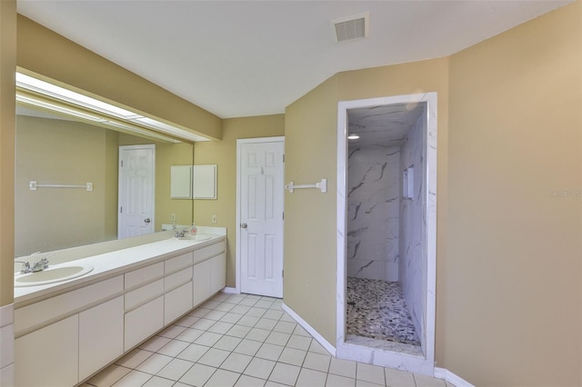 1034 Brighton Way, Lakeland, FL 33813 - bathroom featuring a marble finish shower, double vanity, tile patterned floors, and baseboards