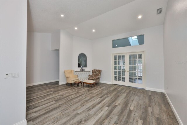 1034 Brighton Way, Lakeland, FL 33813 - living area featuring french doors, wood finished floors, baseboards, recessed lighting, and a towering ceiling