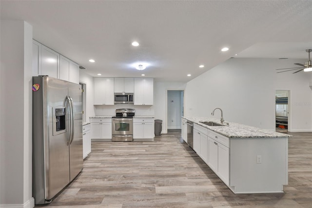 1034 Brighton Way, Lakeland, FL 33813 - kitchen featuring appliances with stainless steel finishes, a sink, recessed lighting, white cabinetry, and light wood-type flooring