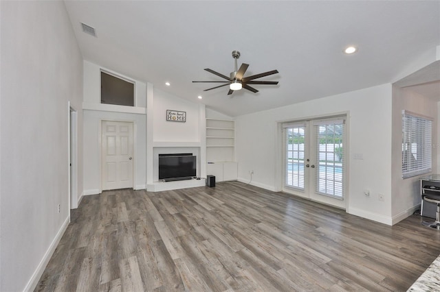 1034 Brighton Way, Lakeland, FL 33813 - unfurnished living room featuring french doors, vaulted ceiling, a ceiling fan, built in features, and baseboards
