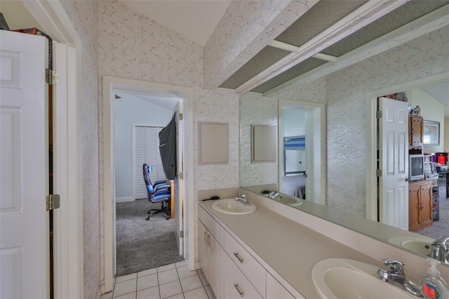 1034 Brighton Way, Lakeland, FL 33813 - bathroom featuring wallpapered walls, double vanity, tile patterned flooring, and lofted ceiling