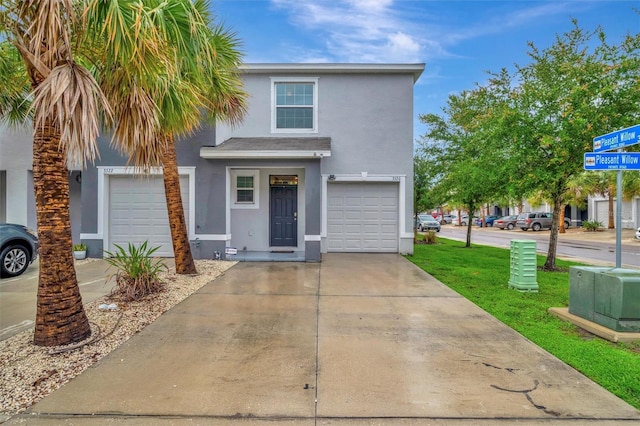 3320 Pleasant Willow Ct, Brandon, FL 33511 - traditional-style house featuring stucco siding, driveway, an attached garage, and a front lawn