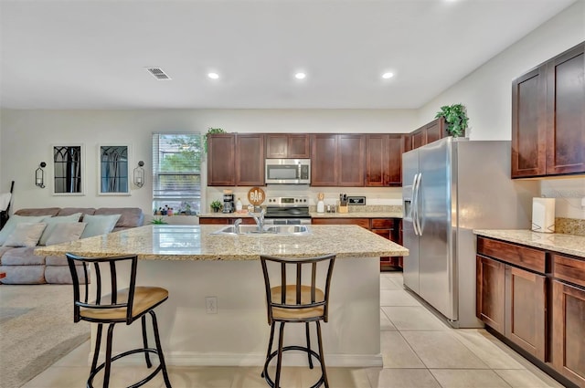 3320 Pleasant Willow Ct, Brandon, FL 33511 - kitchen with stainless steel appliances, a sink, a kitchen breakfast bar, open floor plan, and recessed lighting