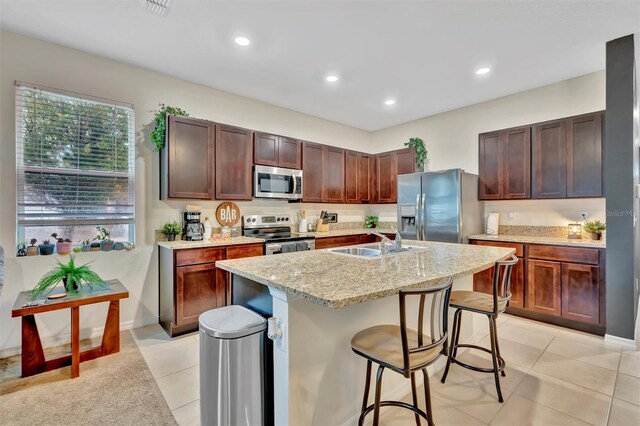 3320 Pleasant Willow Ct, Brandon, FL 33511 - kitchen featuring stainless steel appliances, a sink, a breakfast bar, a kitchen island with sink, and recessed lighting