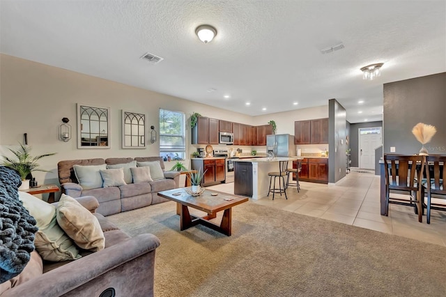 3320 Pleasant Willow Ct, Brandon, FL 33511 - living area featuring a textured ceiling, light tile patterned floors, light colored carpet, and recessed lighting