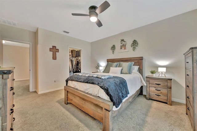 3320 Pleasant Willow Ct, Brandon, FL 33511 - bedroom featuring light carpet, a spacious closet, baseboards, and ceiling fan