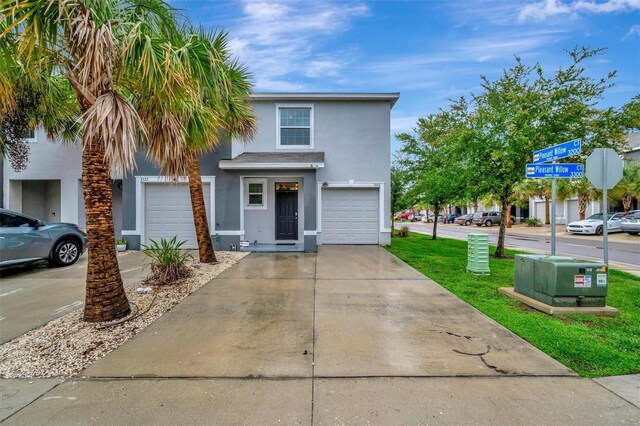 3320 Pleasant Willow Ct, Brandon, FL 33511 - view of front of home with stucco siding, concrete driveway, and a garage