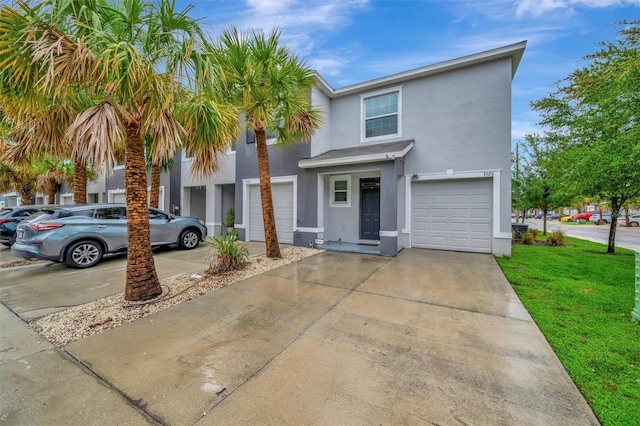 3320 Pleasant Willow Ct, Brandon, FL 33511 - townhome / multi-family property featuring stucco siding, a garage, a front yard, and driveway