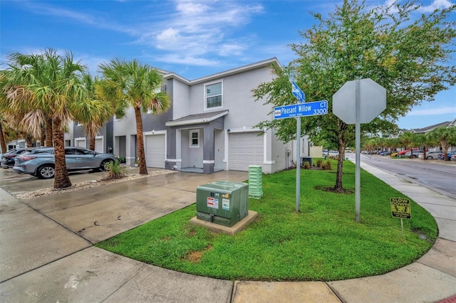 3320 Pleasant Willow Ct, Brandon, FL 33511 - townhome / multi-family property featuring stucco siding, driveway, a front lawn, and a garage