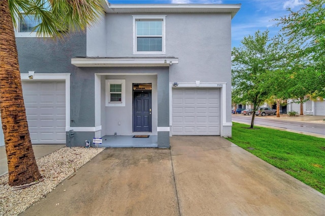 3320 Pleasant Willow Ct, Brandon, FL 33511 - view of front of home featuring stucco siding, an attached garage, and driveway