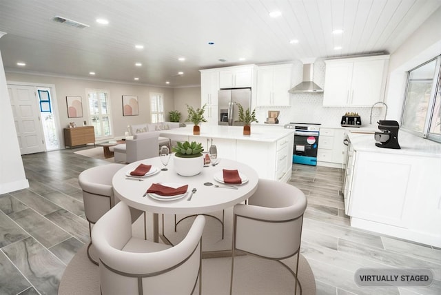 913 Spindle Palm Way, Apollo Beach, FL 33572 - dining area with recessed lighting, ornamental molding, and light wood-style flooring
