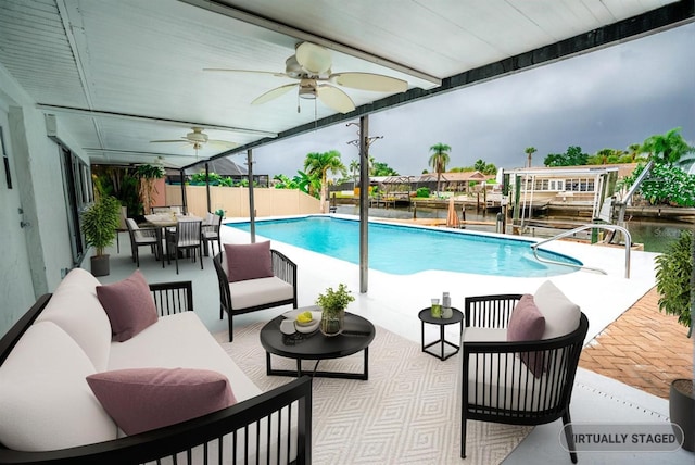 913 Spindle Palm Way, Apollo Beach, FL 33572 - view of pool with ceiling fan, a patio area, outdoor dining area, a water view, and an outdoor hangout area