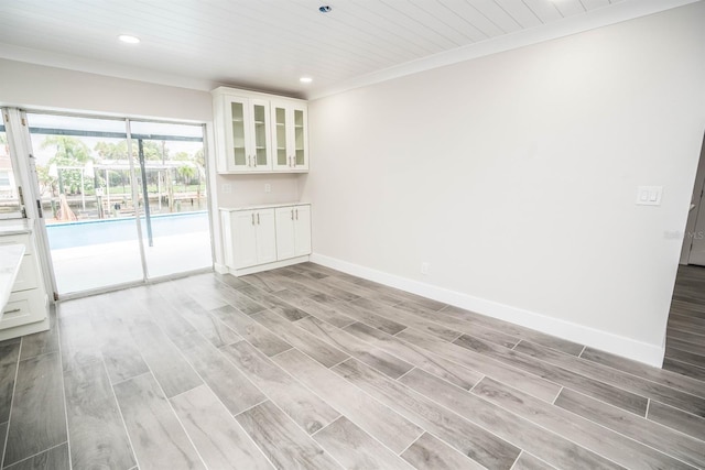 913 Spindle Palm Way, Apollo Beach, FL 33572 - empty room featuring recessed lighting, baseboards, light wood-style floors, wood ceiling, and crown molding