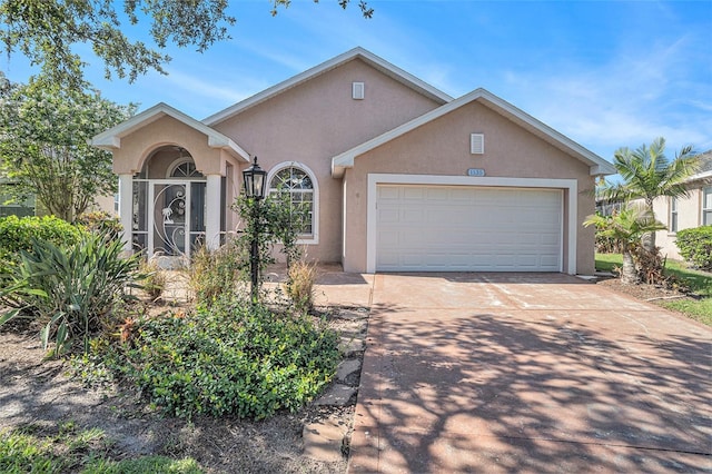 1135 Millbrook Cir, Bradenton, FL 34212 - view of front of house with stucco siding, a garage, and driveway