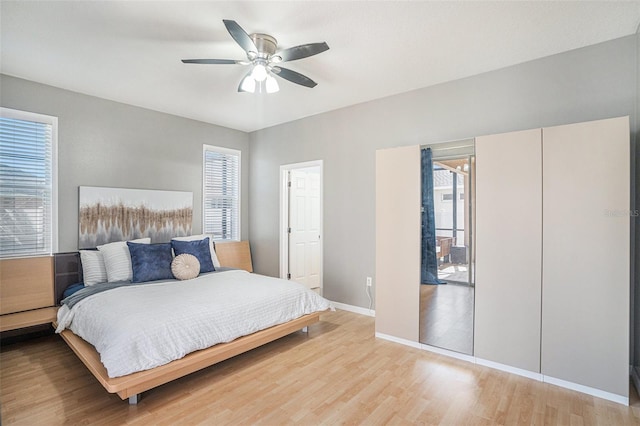 1135 Millbrook Cir, Bradenton, FL 34212 - bedroom with multiple windows, light wood-type flooring, and a ceiling fan