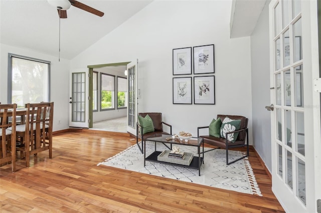 18914 Geraci Rd, Lutz, FL 33548 - living area featuring light wood-style flooring, high vaulted ceiling, a ceiling fan, and french doors