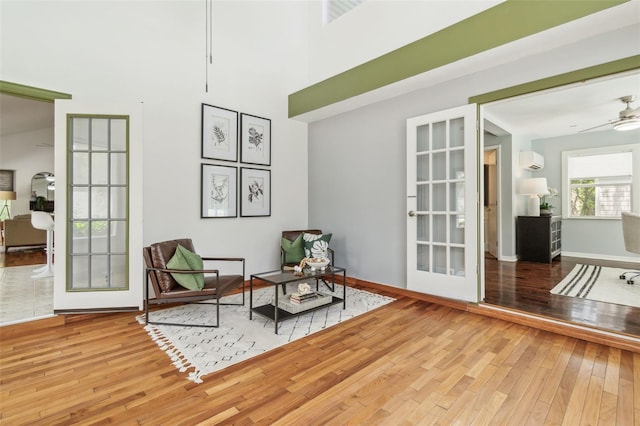 18914 Geraci Rd, Lutz, FL 33548 - sitting room with wood-type flooring, a ceiling fan, and a towering ceiling