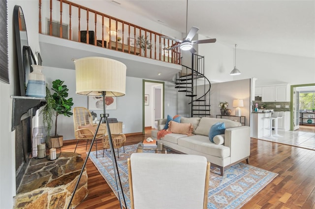 18914 Geraci Rd, Lutz, FL 33548 - living room with high vaulted ceiling, stairs, wood finished floors, and a ceiling fan