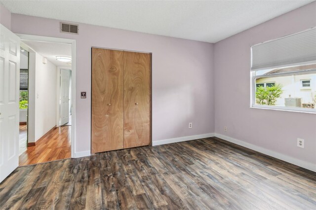 18914 Geraci Rd, Lutz, FL 33548 - unfurnished bedroom with wood finished floors, multiple windows, and a closet