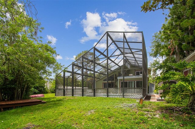 18914 Geraci Rd, Lutz, FL 33548 - back of house featuring a yard, a lanai, and a deck