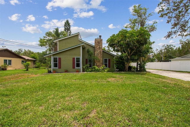 18914 Geraci Rd, Lutz, FL 33548 - back of house featuring a chimney and concrete driveway