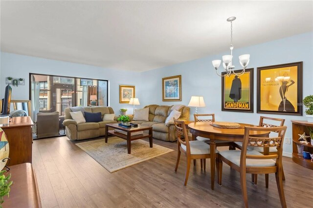 2400 Winding Creek Blvd Unit 4-101, Clearwater, FL 33761 - living area featuring a chandelier and wood finished floors