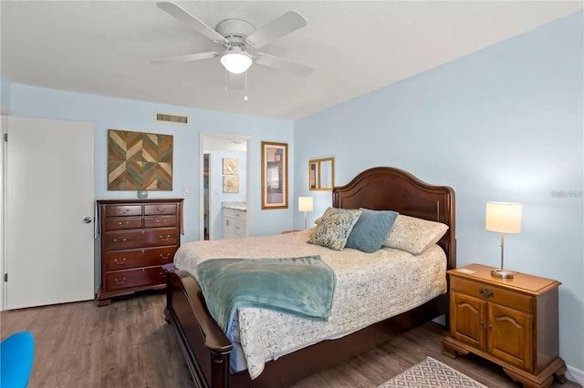 2400 Winding Creek Blvd Unit 4-101, Clearwater, FL 33761 - bedroom with dark wood-style flooring, a ceiling fan, and ensuite bath