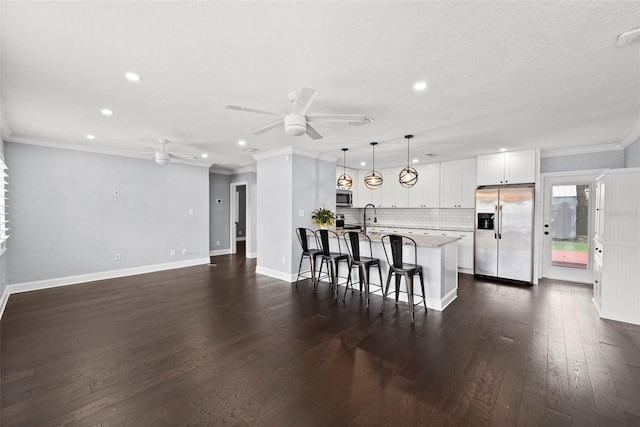 3906 W Rogers Ave, Tampa, FL 33611 - kitchen with appliances with stainless steel finishes, a ceiling fan, a breakfast bar, recessed lighting, and dark wood finished floors