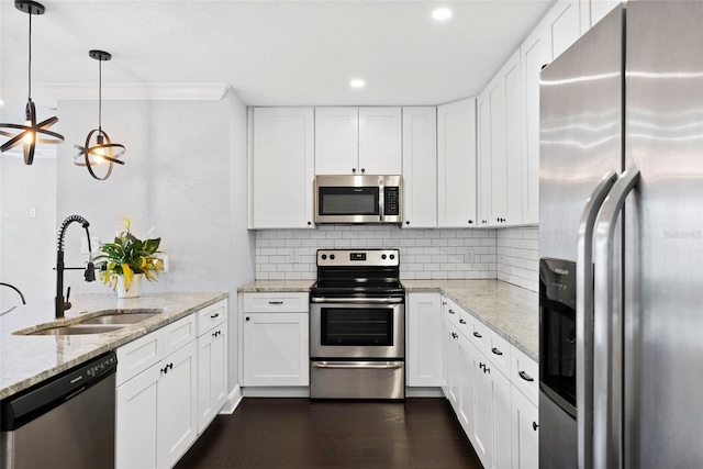3906 W Rogers Ave, Tampa, FL 33611 - kitchen featuring stainless steel appliances, a sink, white cabinetry, crown molding, and recessed lighting