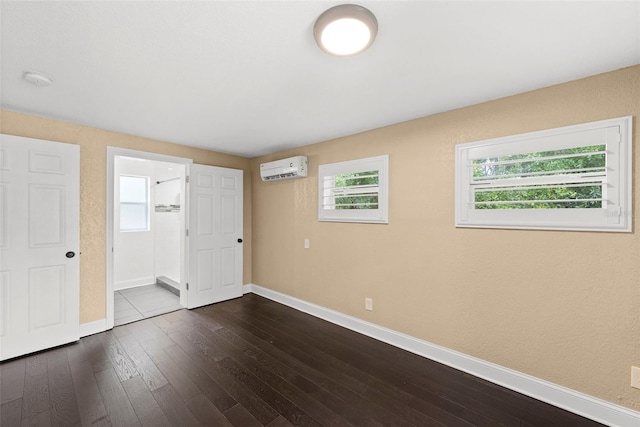 3906 W Rogers Ave, Tampa, FL 33611 - unfurnished bedroom with baseboards, dark wood finished floors, and a wall mounted air conditioner